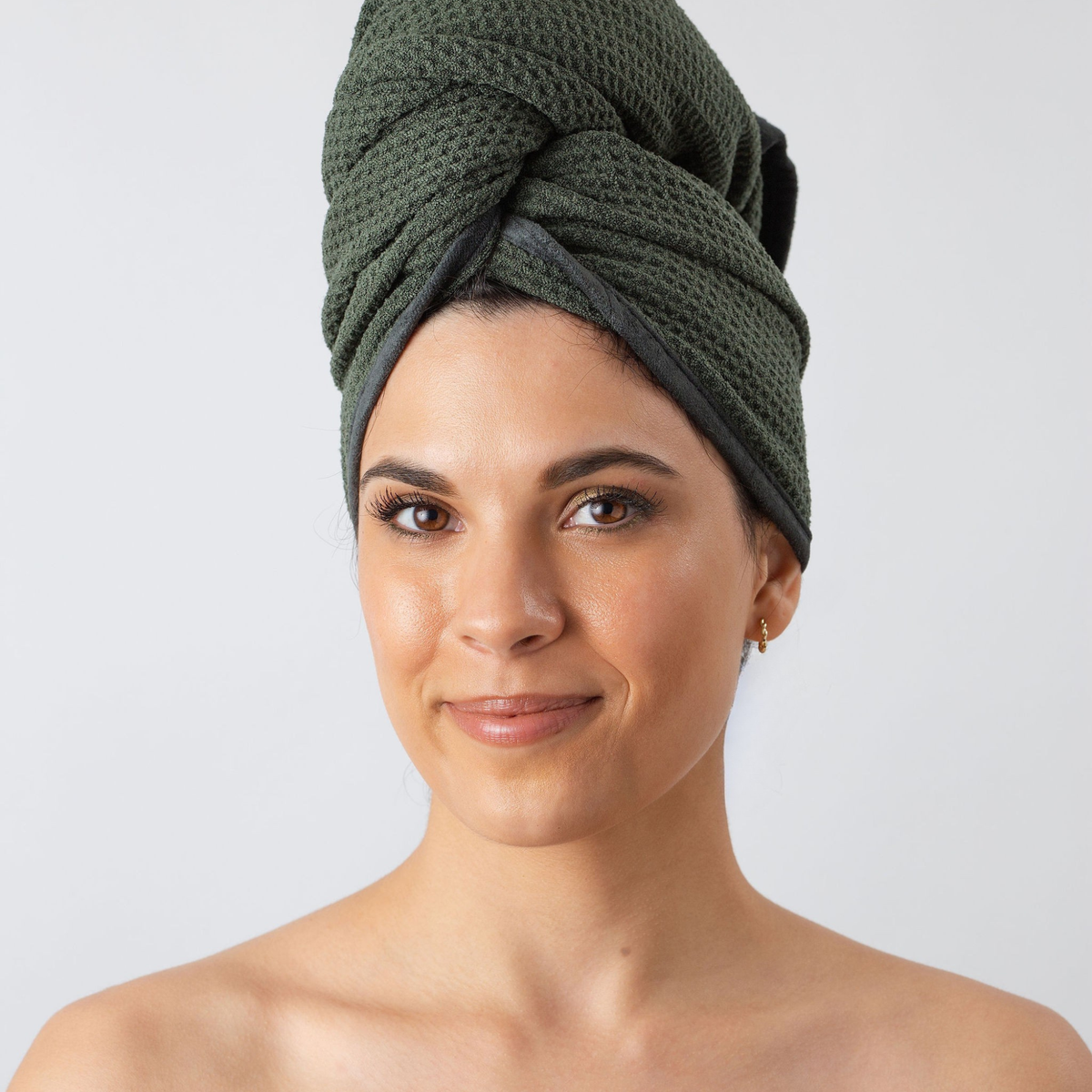 Woman with her hair wrapped in the GWEN Hair Towel in Moss, a waffle weave microfiber hair towel.