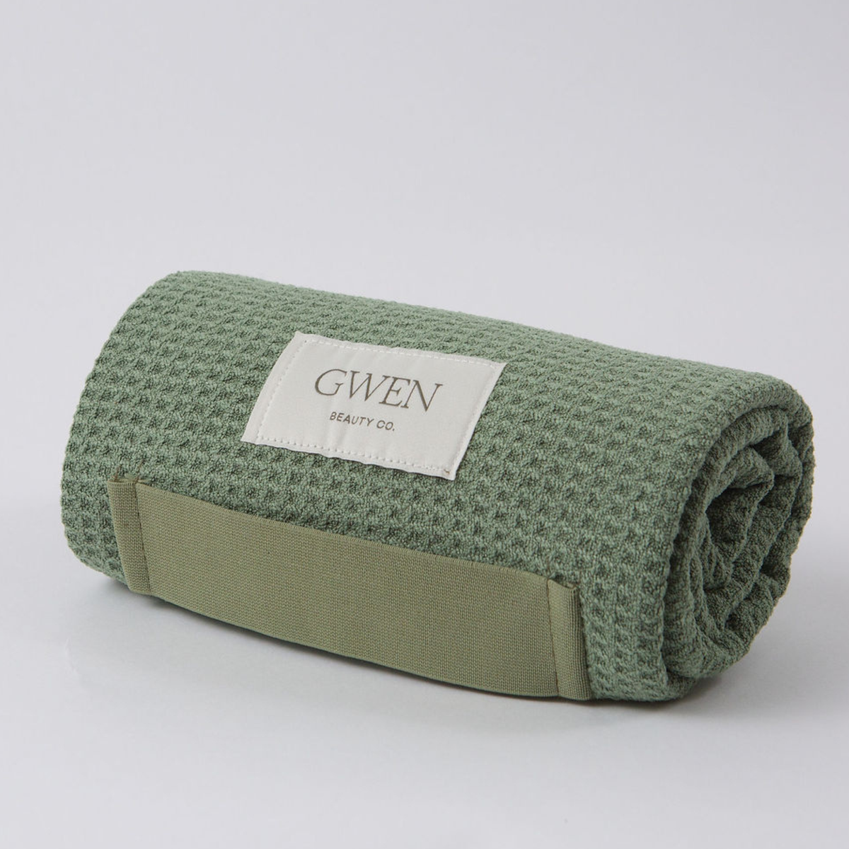 The GWEN Hair Towel in Sage rolled up, showing the waffle weave microfiber texture.