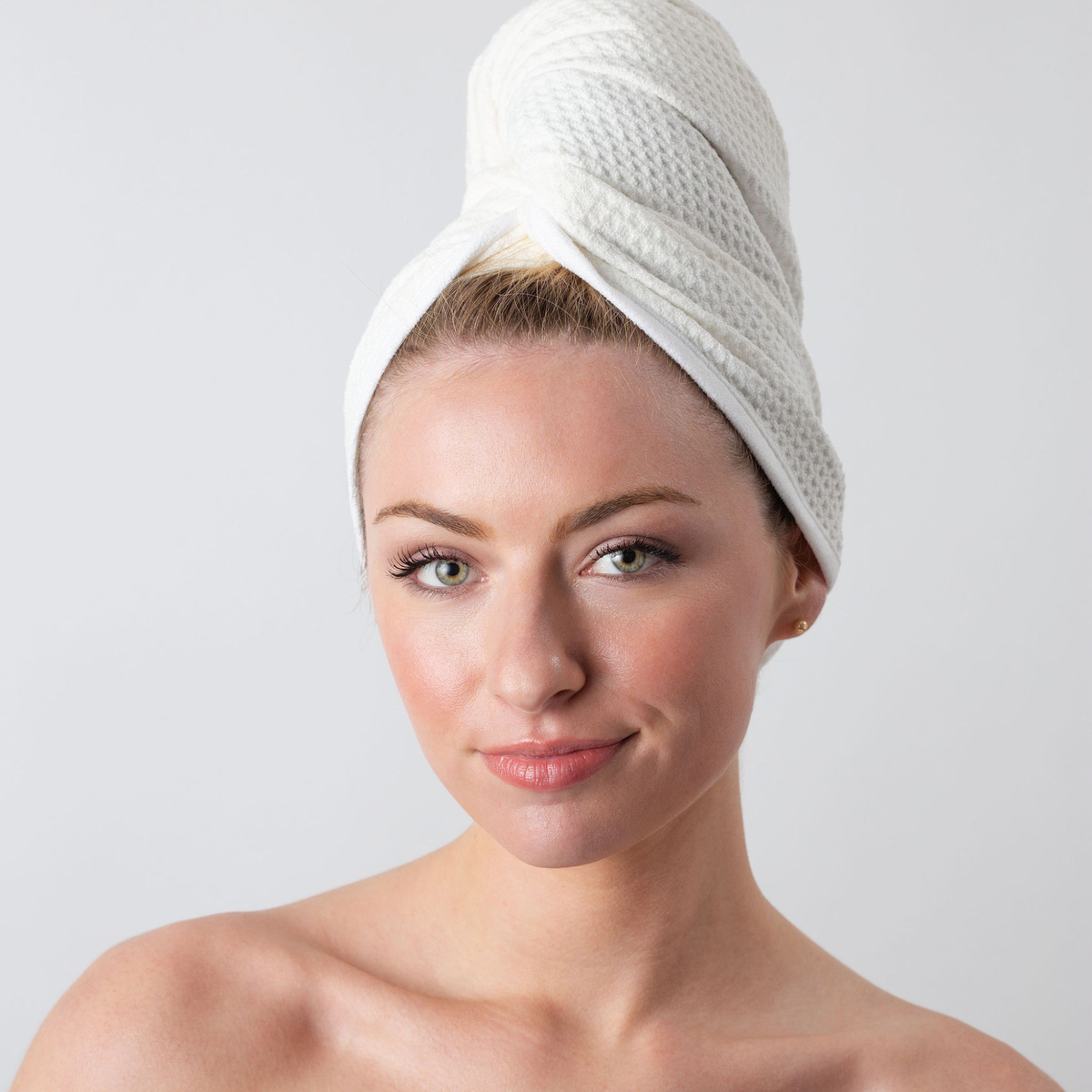 Woman with her hair wrapped in the GWEN Hair Towel in Ivory, a waffle weave microfiber hair towel.
