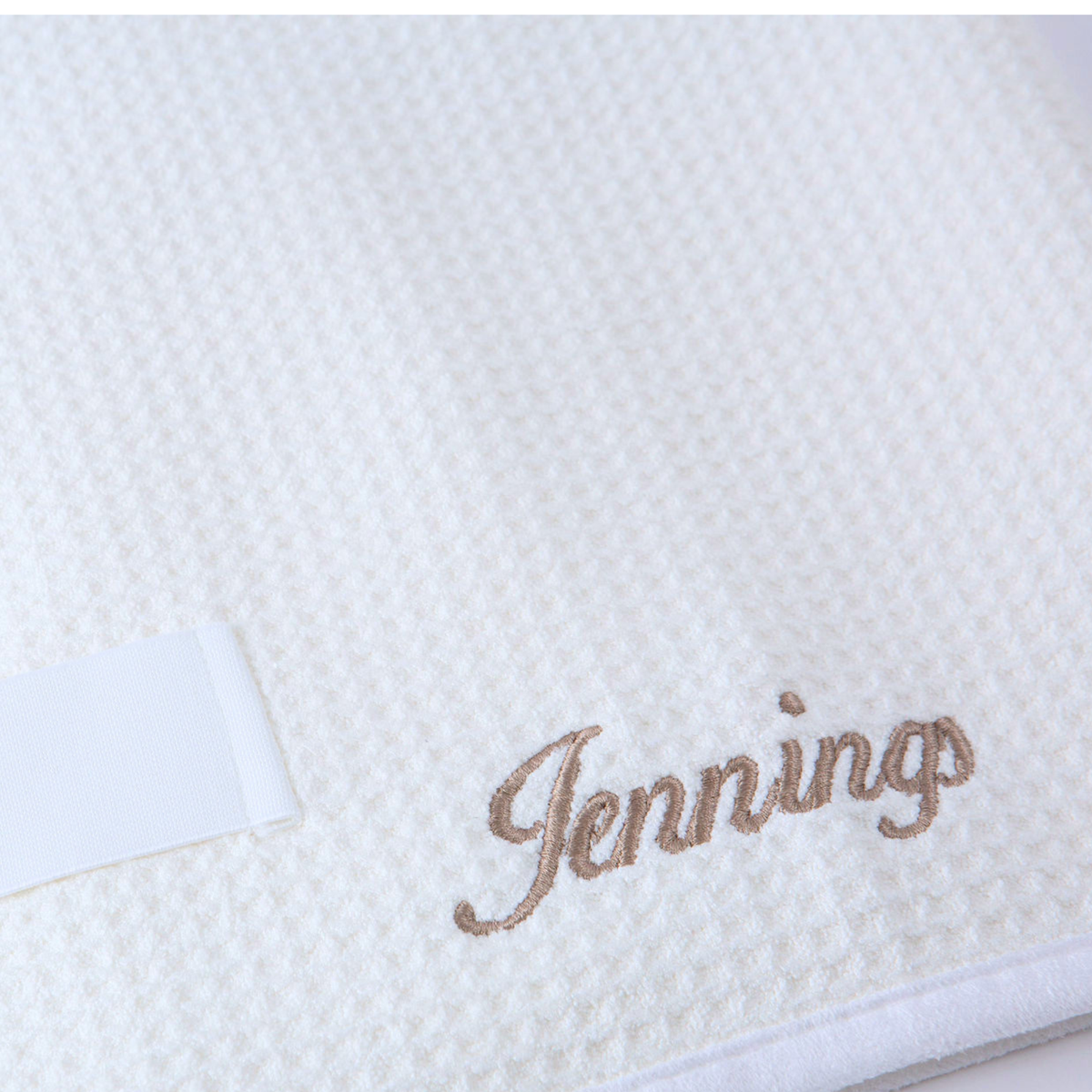 Close-up of the GWEN Hair Towel in Ivory with an embroidered monogram, showing the personalization add-on.