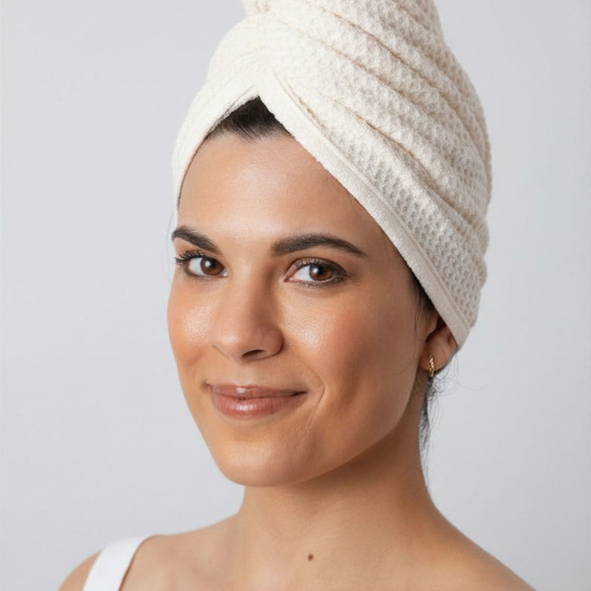 Woman with her hair wrapped in the GWEN Hair Towel in Linen, a waffle weave microfiber hair towel.