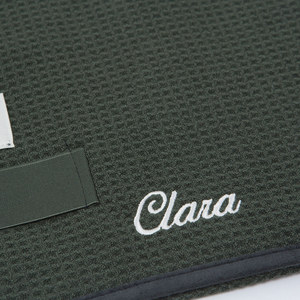 Close-up of the GWEN Hair Towel in Moss with an embroidered monogram, showing the personalization add-on.