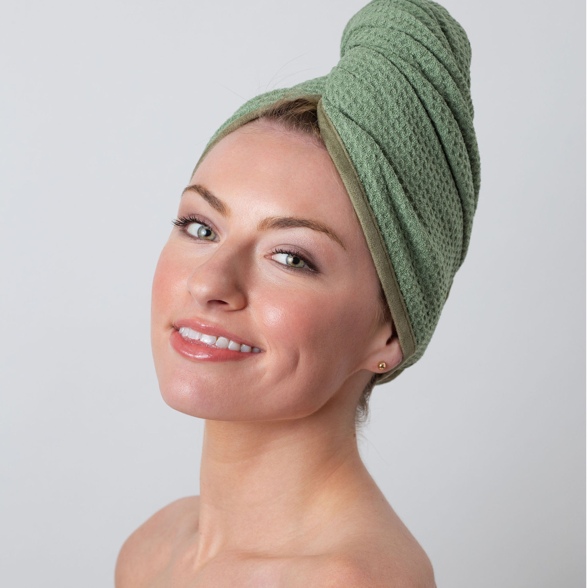 Woman with her hair wrapped in the GWEN Hair Towel in Sage, a waffle weave microfiber hair towel.