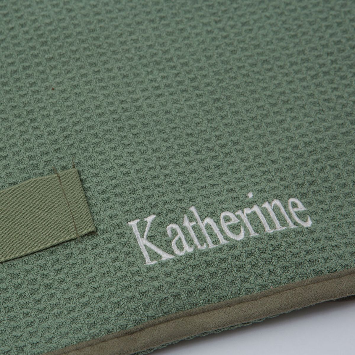 Close-up of the GWEN Hair Towel in Sage with an embroidered monogram, showing the personalization add-on.
