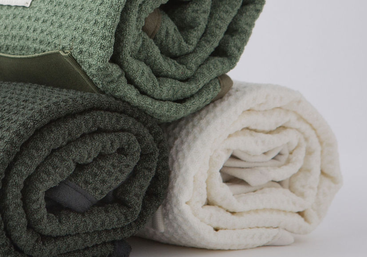 Close-up of three rolled GWEN Hair Towels side by side in Moss, Sage and Ivory, showing the waffle weave microfiber texture.